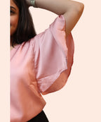 Close-up cape sleeve drape and satin sheen detail women's baby pink V-neck workwear blouse Ladymade