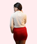Back close-up of textured knit fabric on beige top