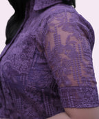 Close-up of embroidered lace detail on grape workwear top