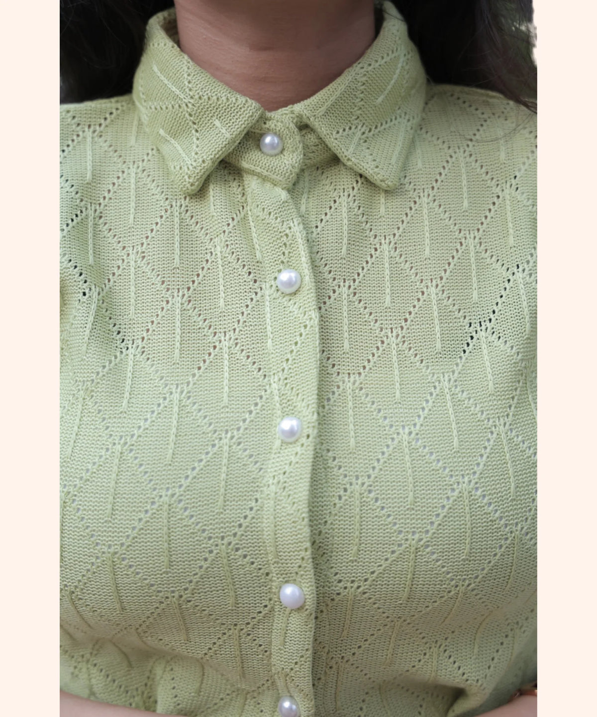 Close-up of pearl button detail on women’s mint green eyelet collared workwear shirt