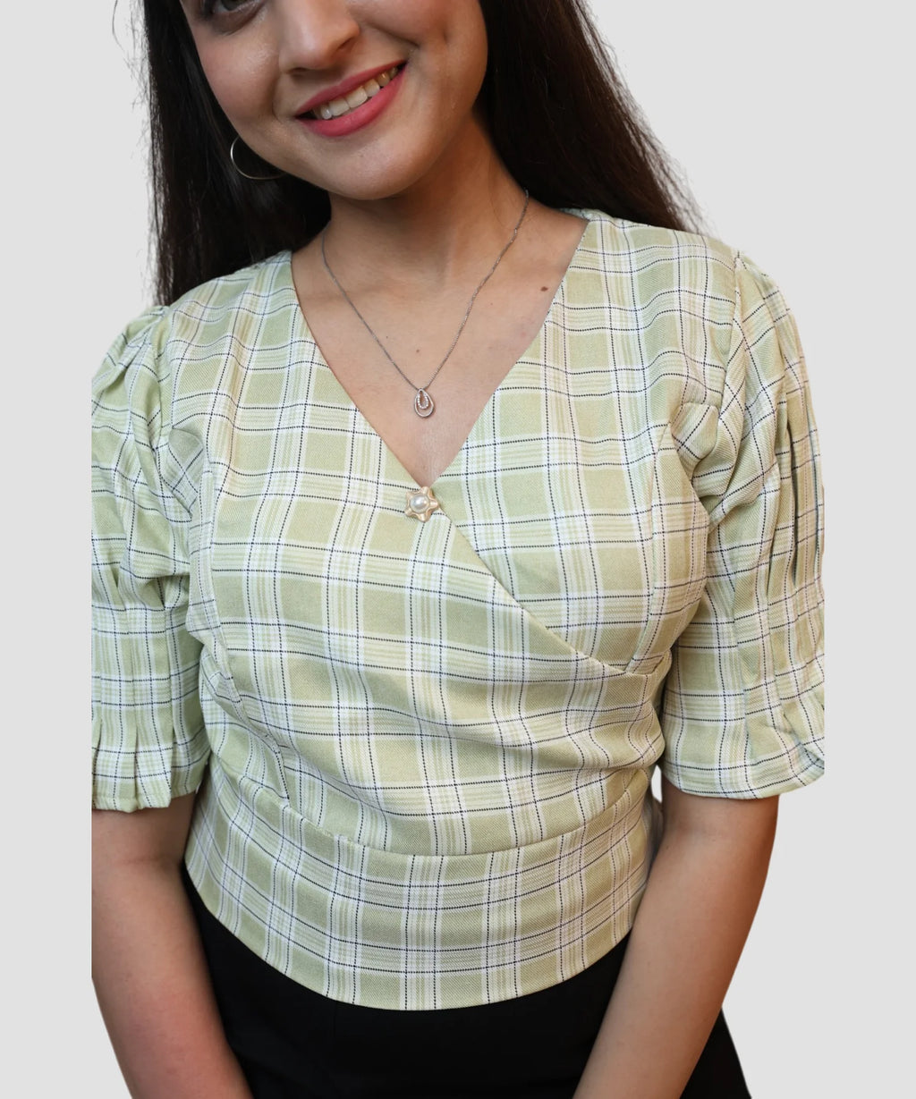 closeup view of pista green check wrap crop top with pearl brooch detail for women