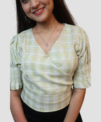 closeup view of pista green check wrap crop top with pearl brooch detail for women