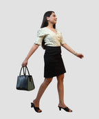 Woman wearing pista green checks wrap crop top puff sleeve modern workwear look