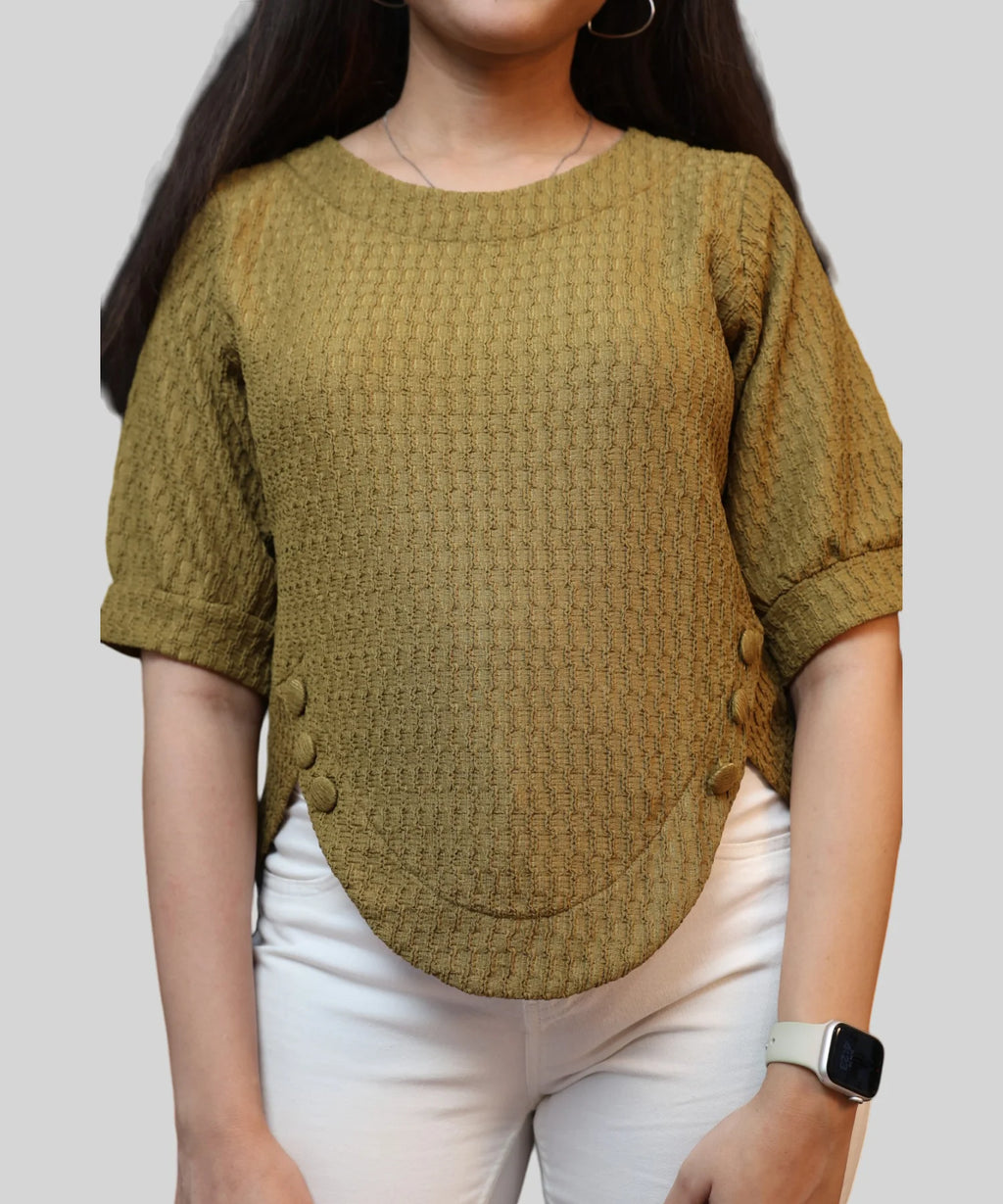 Close-up of textured fabric on olive top