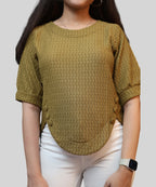 Close-up of textured fabric on olive top