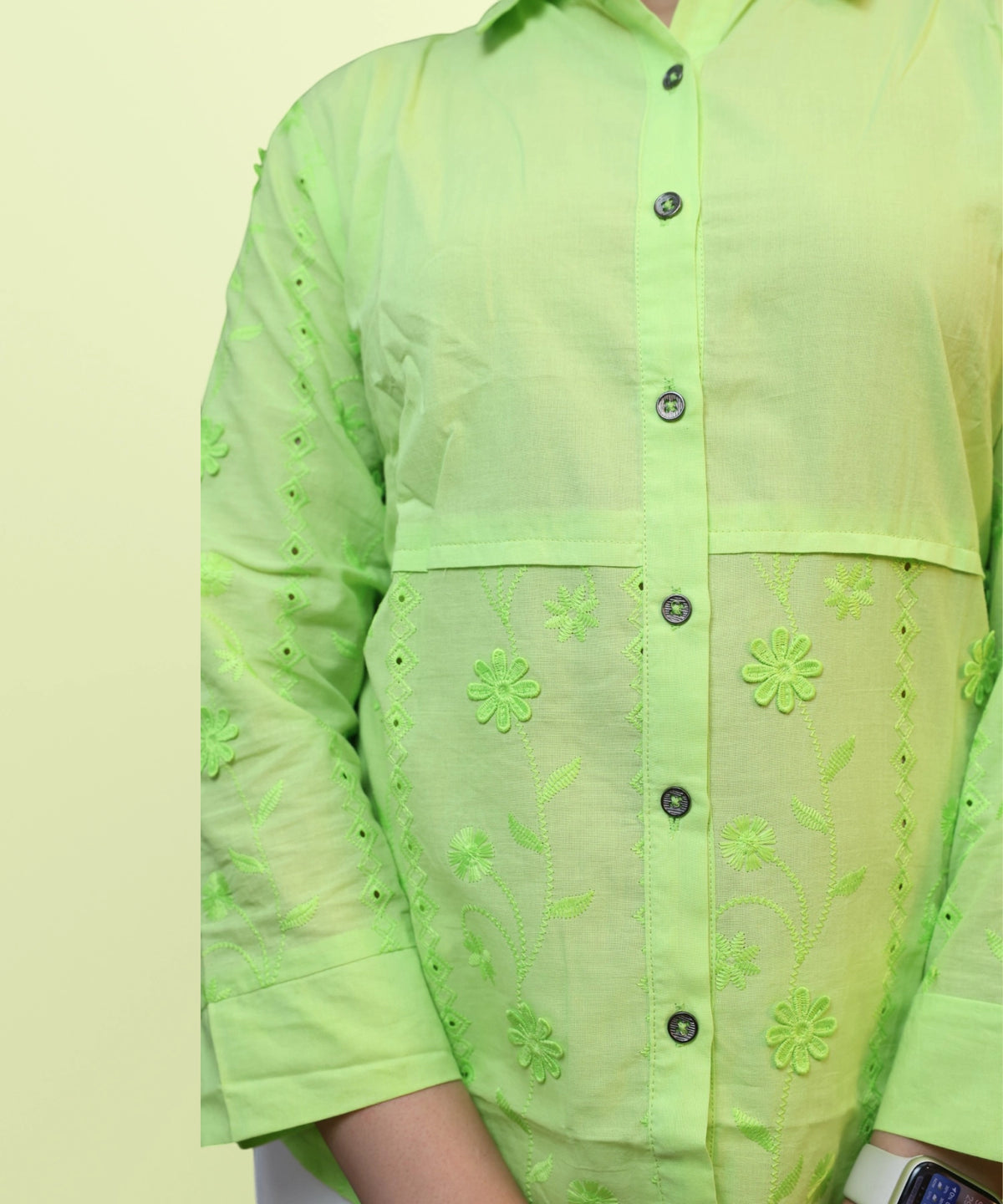 Close-up of schiffli floral embroidery and dark button placket on parrot green workwear shirt Ladymade