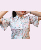 Close-up women's sky blue floral collared shirt flutter sleeves fully spread drawstring shoulder detail Ladymade