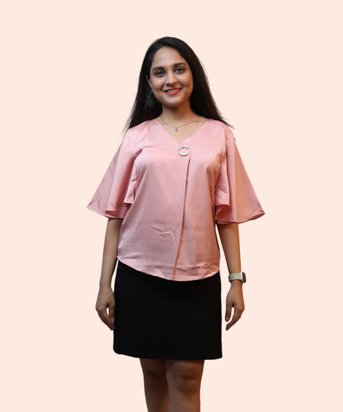 Full length women's baby pink satin cape sleeve top silver brooch V-neck detail black skirt Ladymade