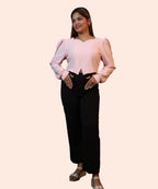 Dynamic candid shot of a woman modeling a baby pink ribbed long sleeve workwear top with an inverted-V hemline by Ladymade.