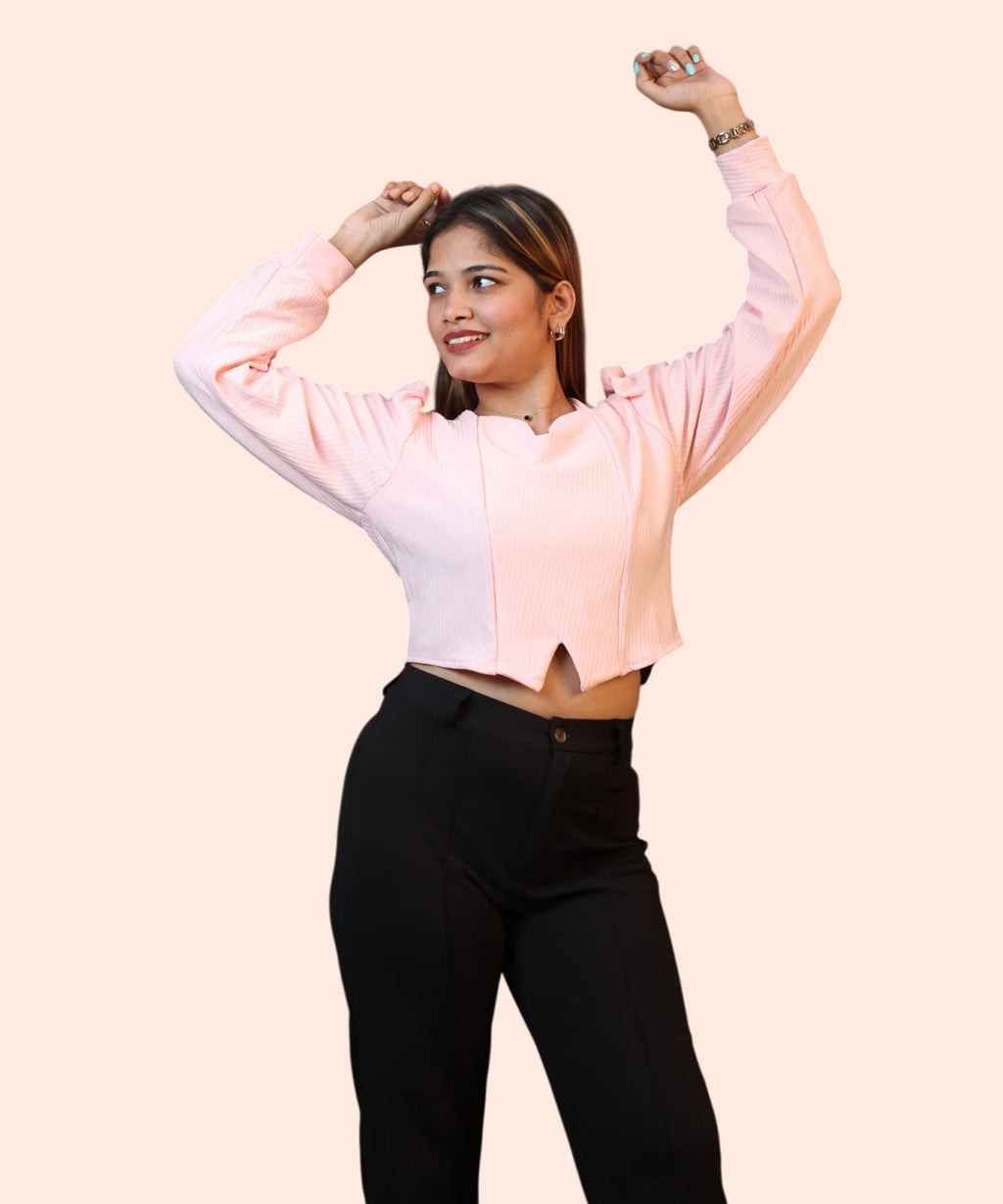 Lifestyle profile shot of a smiling woman talking on her smartphone while wearing a baby pink puff sleeve blouse by Ladymade.