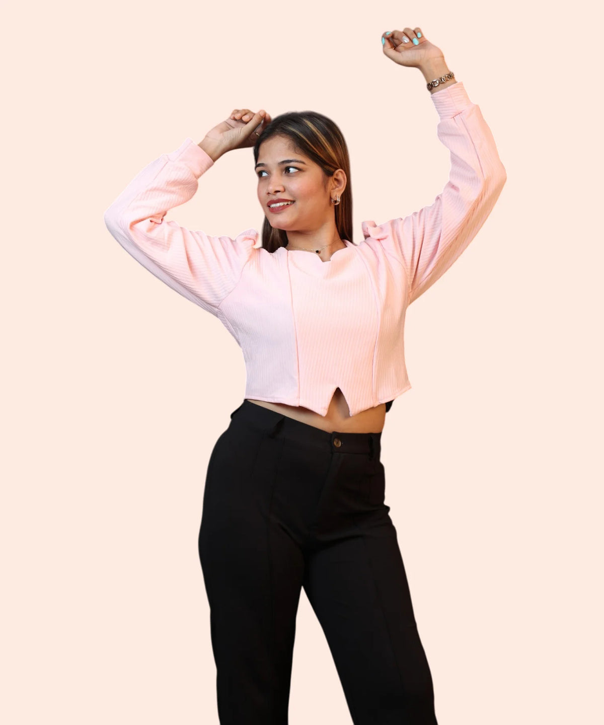 Lifestyle profile shot of a smiling woman talking on her smartphone while wearing a baby pink puff sleeve blouse by Ladymade.