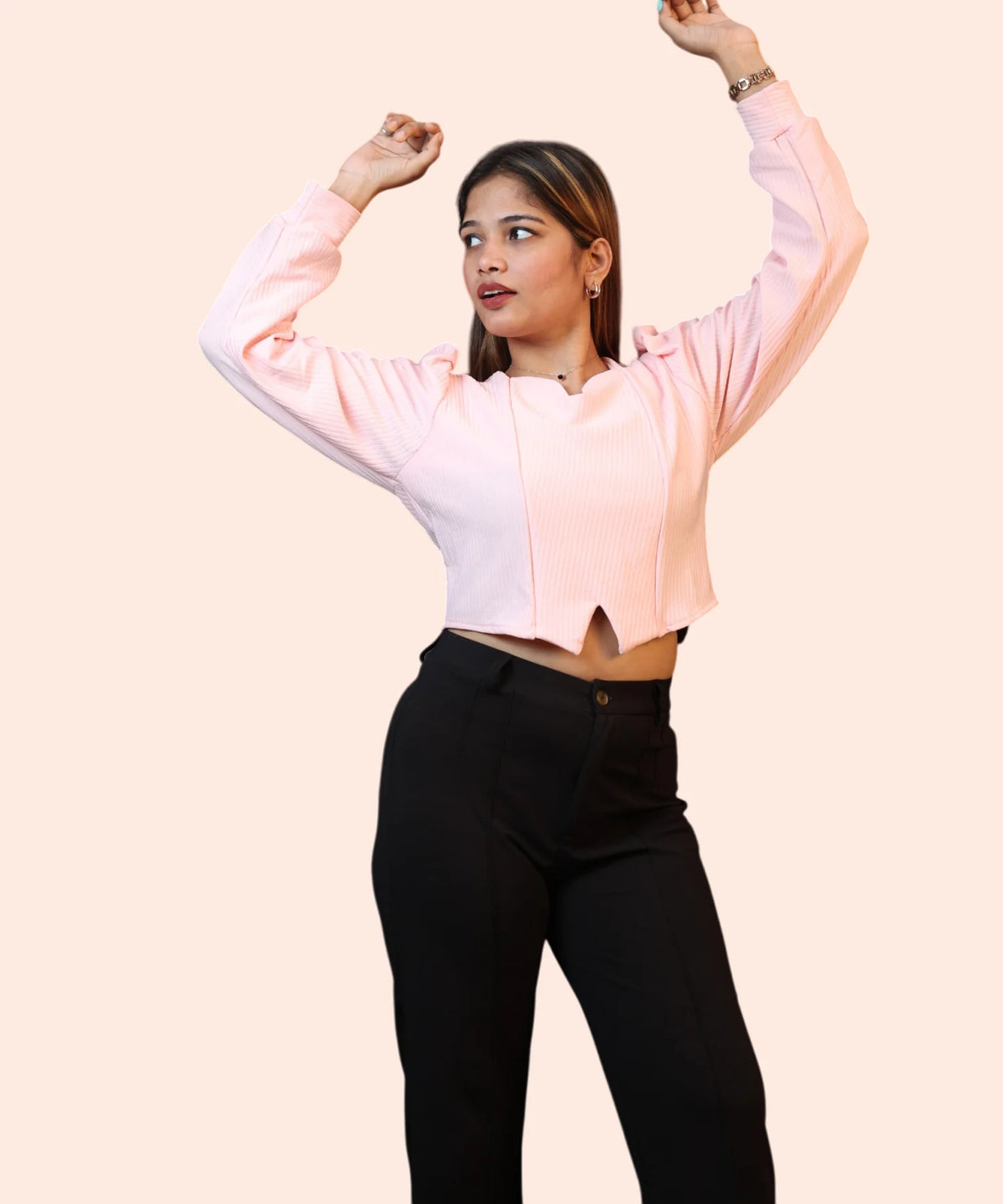 Alternative studio frame capturing a woman showing the fit and sleeve elasticity of a baby pink puff sleeve blouse by Ladymade.