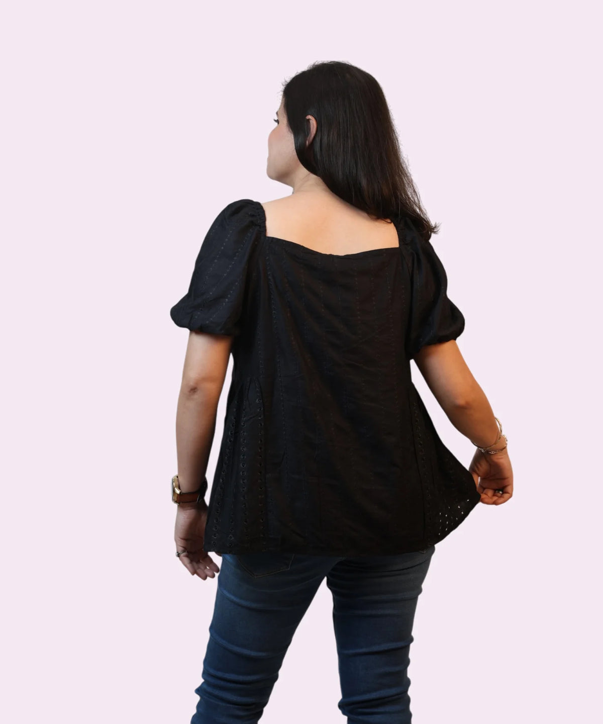 Back angle view showing the square-cut rear yoke and shoulder tailoring of a women's black schiffli office top by Ladymade.