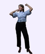 Full length women's blue floral chiffon peplum top dynamic pose puff sleeves black trousers block heels Ladymade