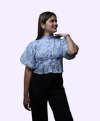Three-quarter angle women's blue floral print high neck peplum top puff sleeve pleated front workwear Ladymade