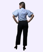 Back view women's blue floral print high neck puff sleeve peplum workwear top black trousers Ladymade