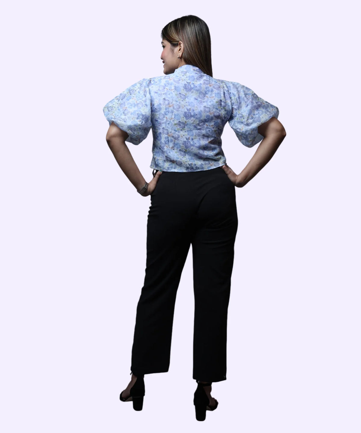 Back view women's blue floral print high neck puff sleeve peplum workwear top black trousers Ladymade