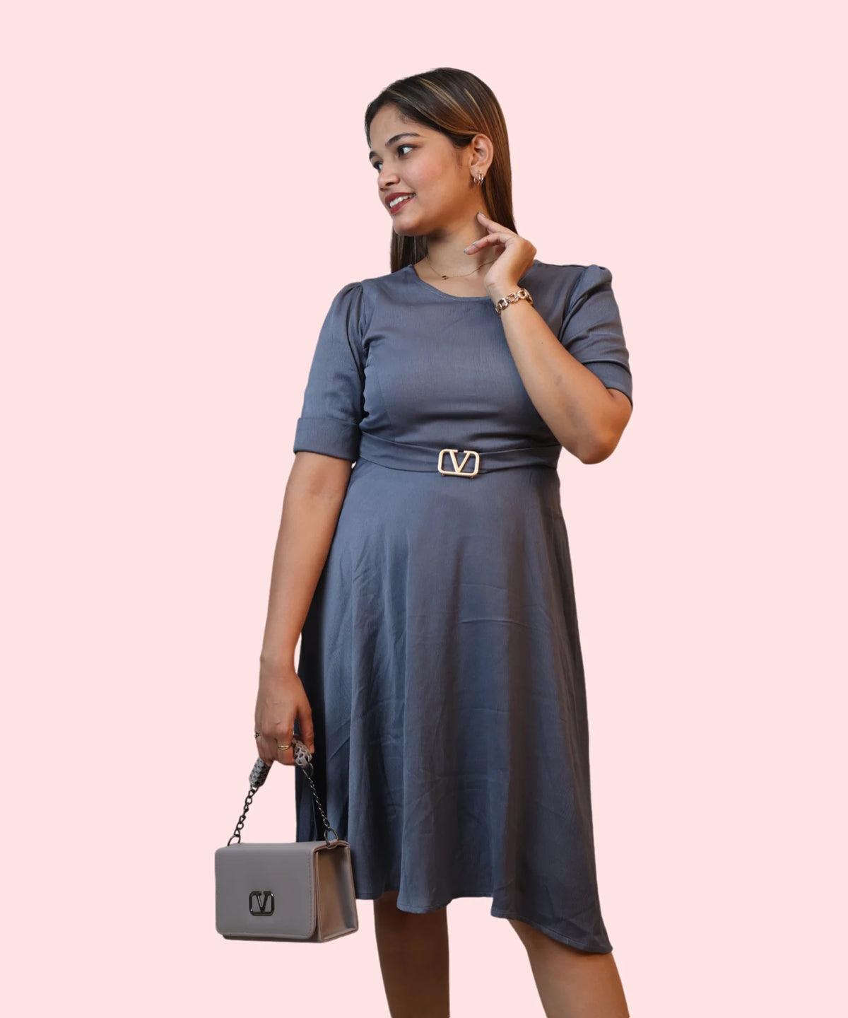 Three-quarter candid profile of a woman wearing an elegant steel grey round neck workwear dress by Ladymade.