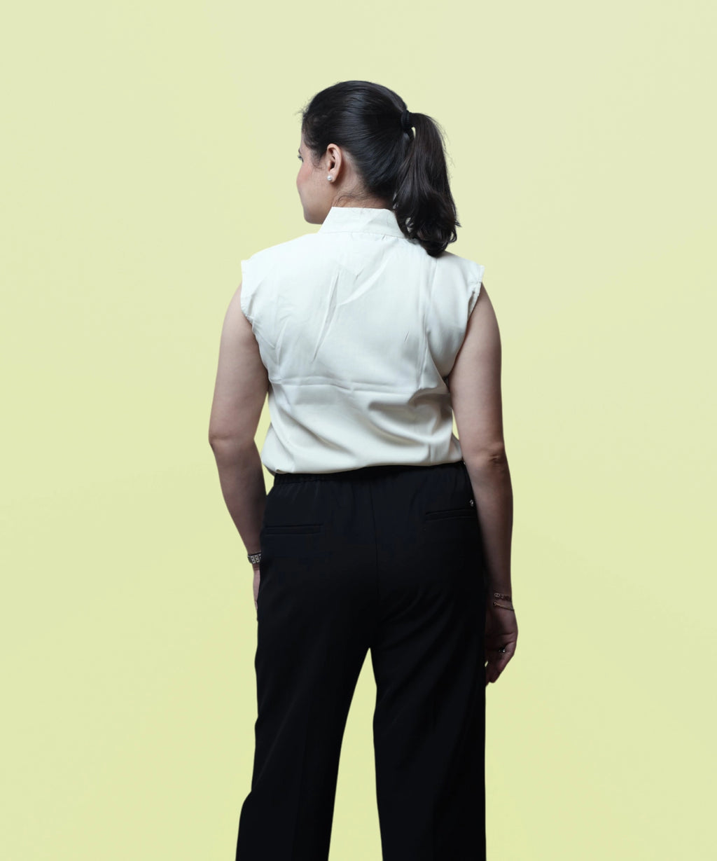 Full back view showcasing the clean shoulder tailoring and regular fit of an ivory formal blouse by Ladymade.