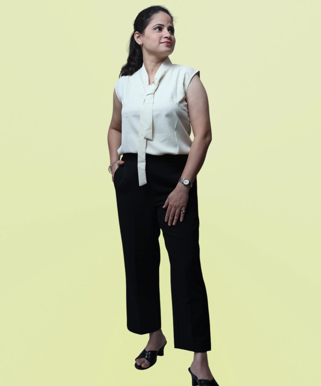 Full-length corporate fashion look featuring an ivory sleeveless polycotton blouse with black trousers by Ladymade.