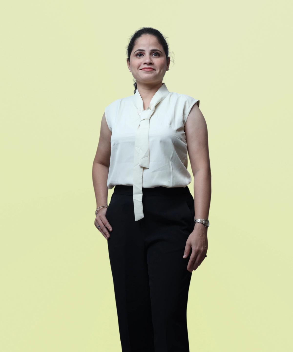 Front view profile of a woman modeling a premium ivory sleeveless tie-neck workwear blouse by Ladymade.
