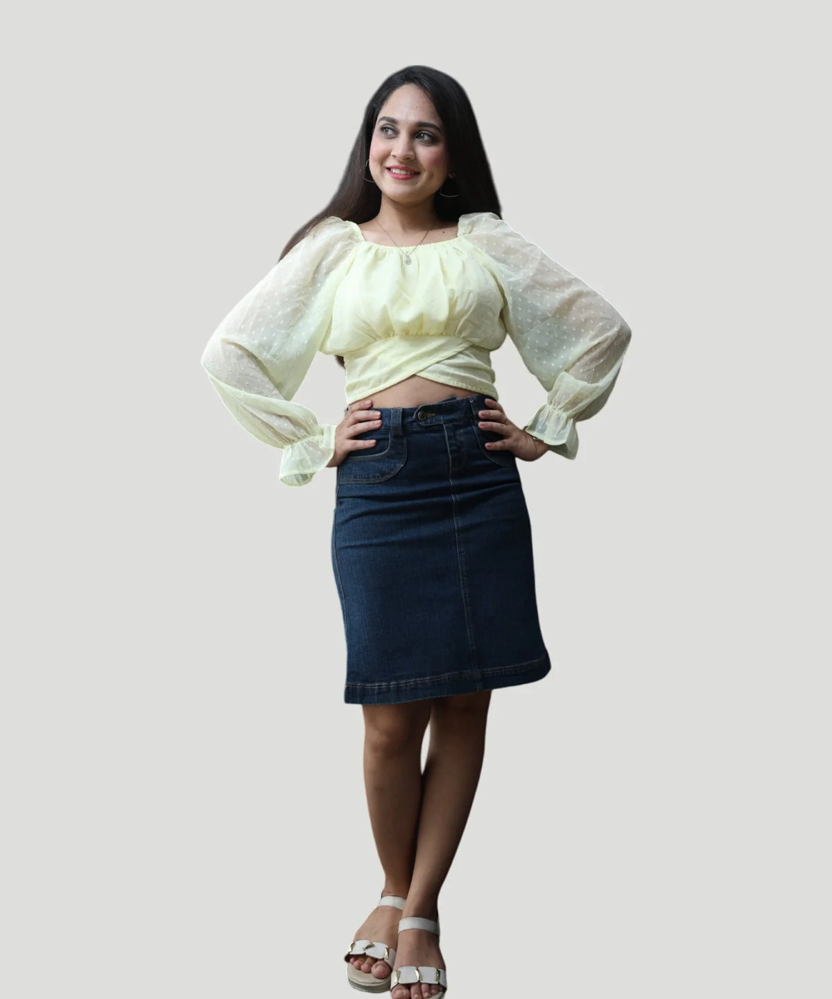 Three-quarter candid pose of a woman wearing an elegant lemon yellow clip-dot chiffon top by Ladymade.