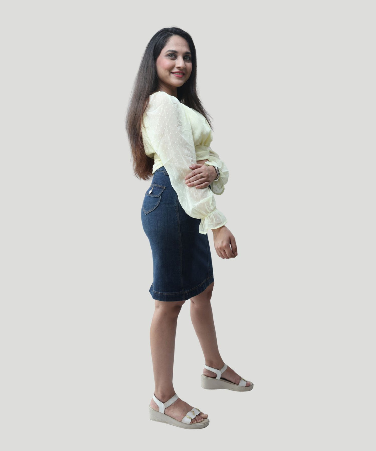 Side profile shot illustrating the long puff sleeves and comfortable crop length of a yellow smart-casual top by Ladymade.