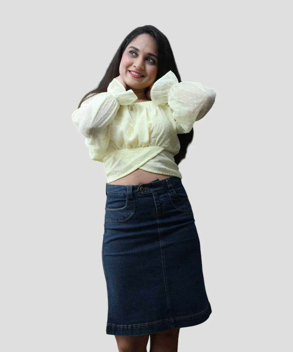 Symmetrical standing front shot of a woman wearing a lemon yellow chiffon puff sleeve top by Ladymade.