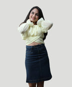Symmetrical standing front shot of a woman wearing a lemon yellow chiffon puff sleeve top by Ladymade.