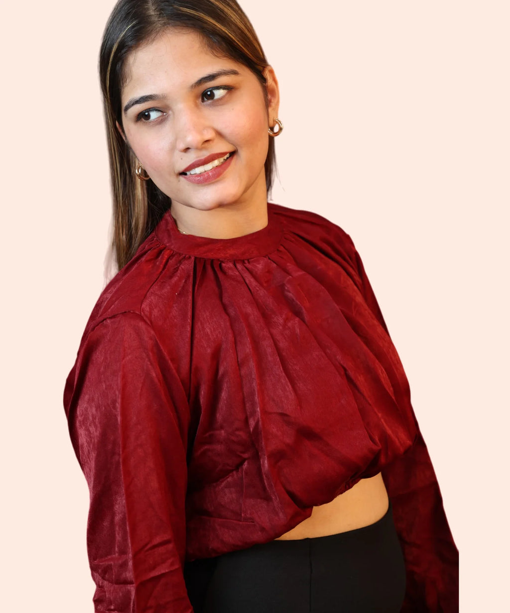 Close-up portrait shot highlighting the gathered mock neckline and plush texture of a maroon velvet blouse by Ladymade.