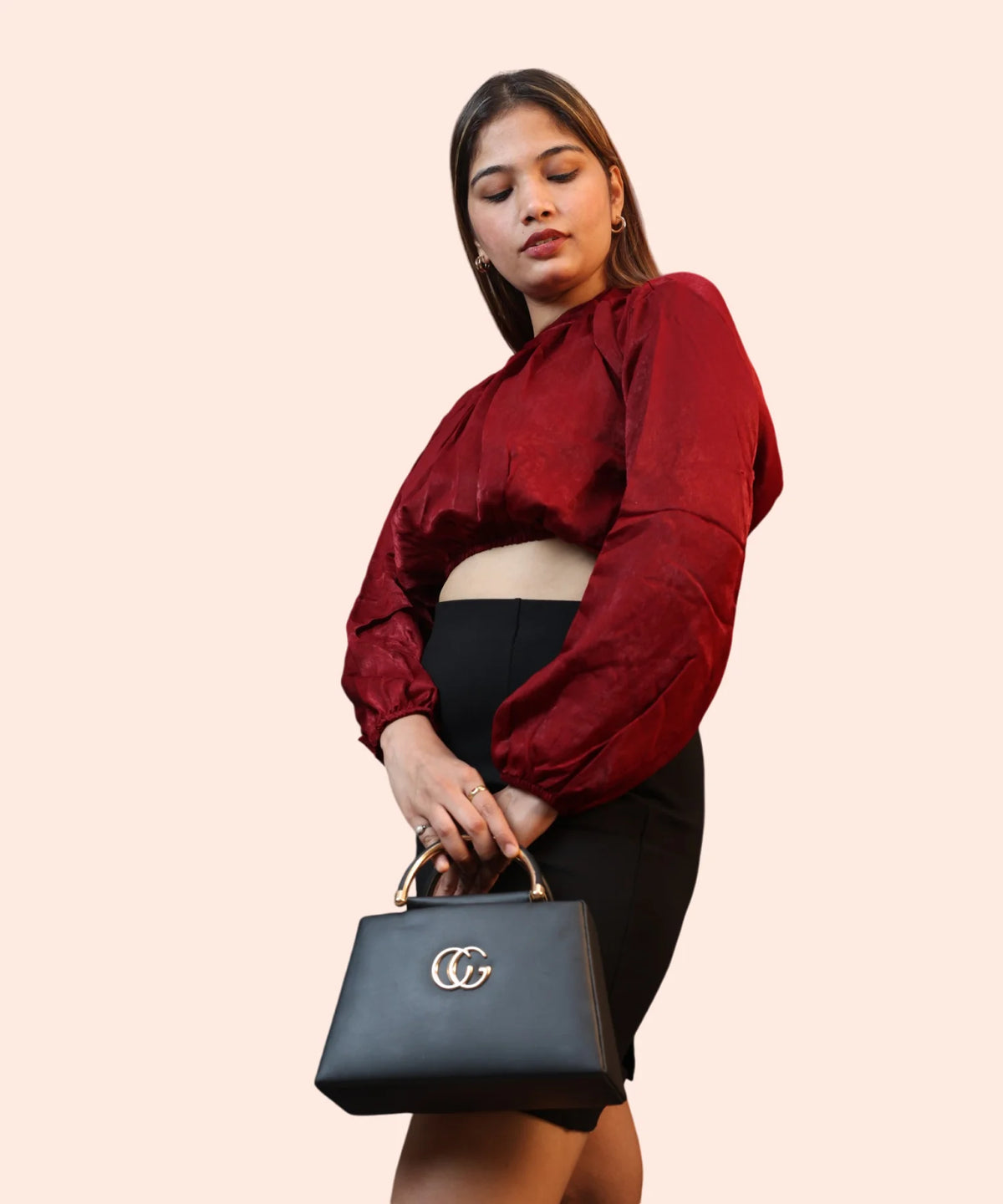 A woman modeling a regular-fit maroon velvet workwear top paired with a high-waisted black skirt by Ladymade.