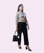 A professional office look featuring a multi-colored satin tribal print top and black wide-leg trousers by Ladymade.