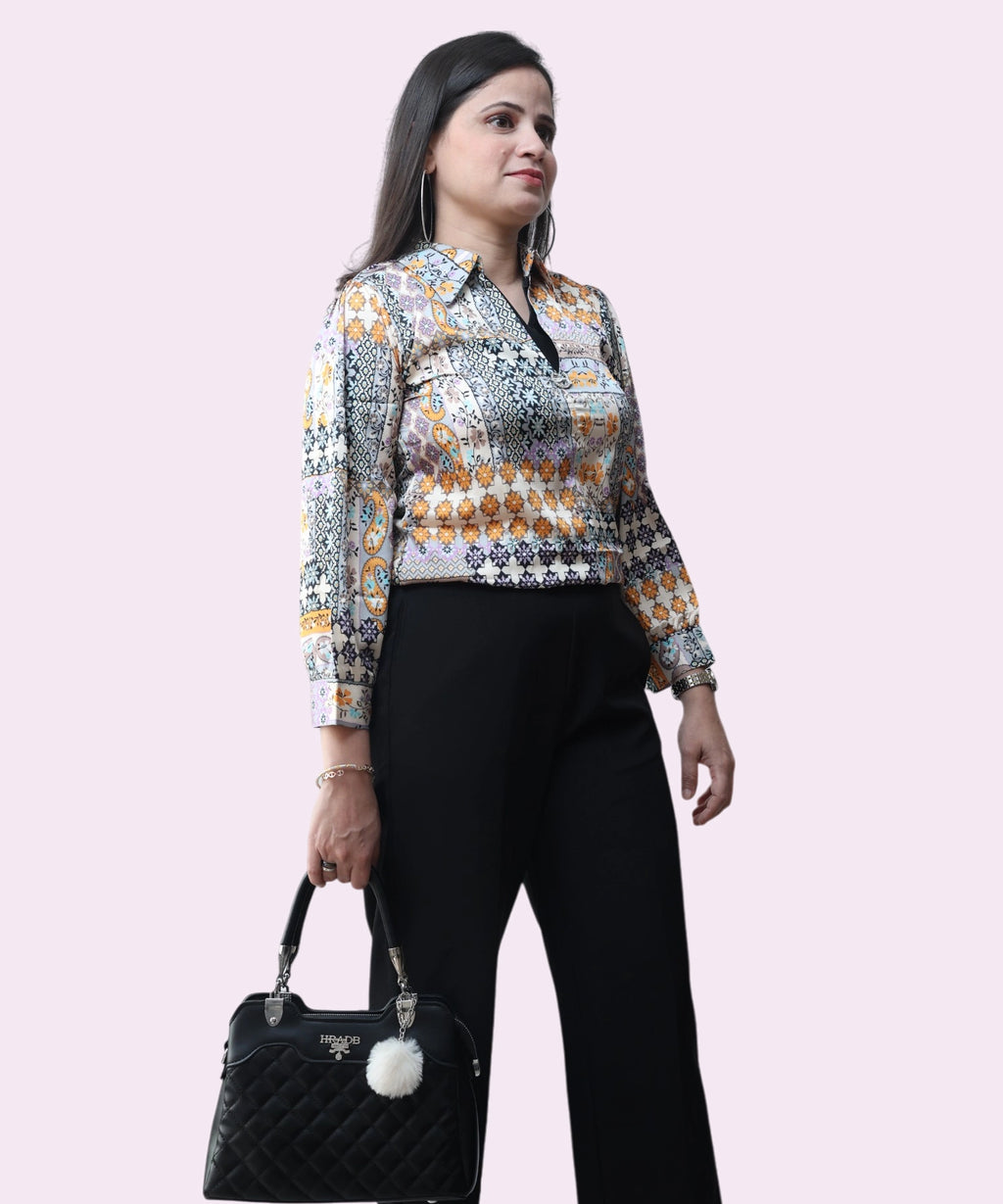 Professional lifestyle shot of a woman wearing a multi-colored satin formal top for office and evening wear by Ladymade.