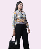 Professional lifestyle shot of a woman wearing a multi-colored satin formal top for office and evening wear by Ladymade.