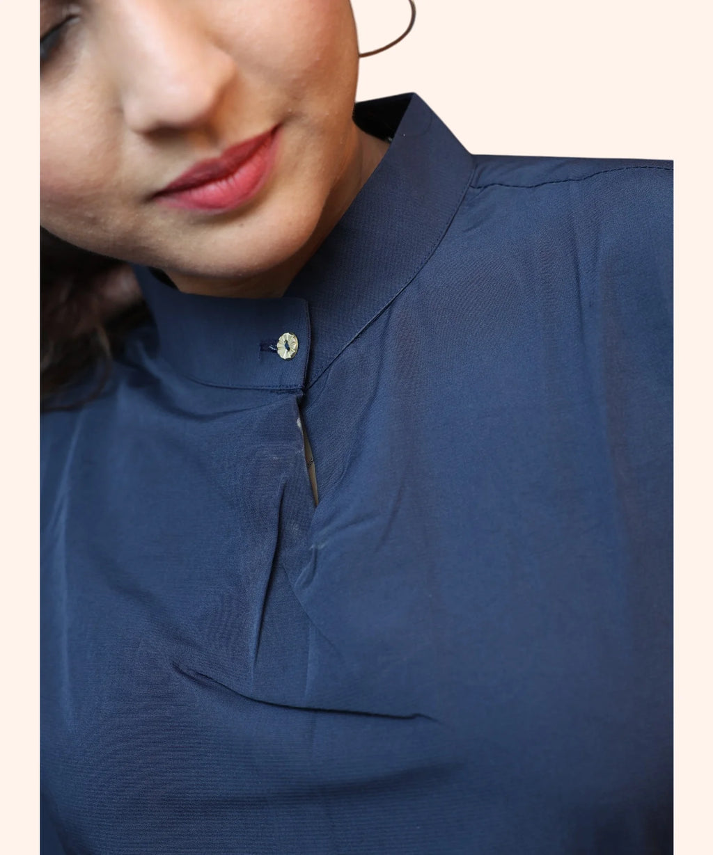 Close-up texture view showing the premium mandarin collar and metallic button detailing on a navy blue formal top by Ladymade.
