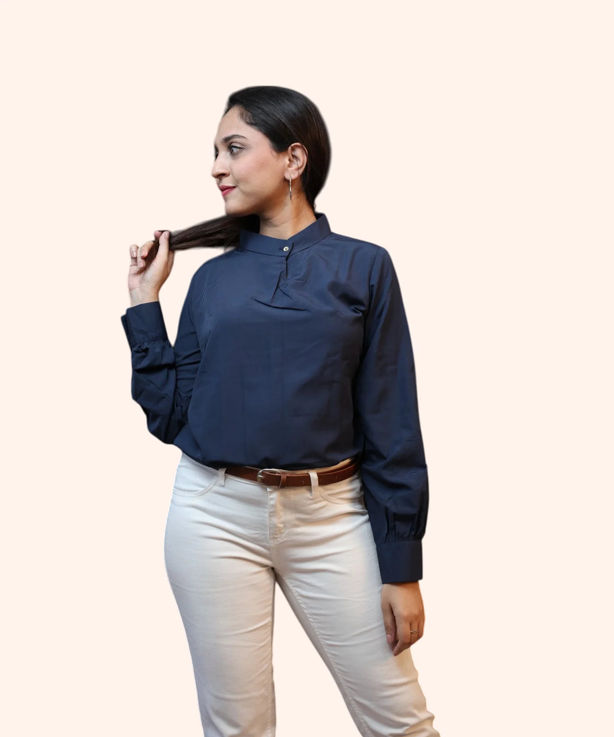 Symmetrical full-length front view of a woman posing in a structured navy blue mandarin collar workwear blouse by Ladymade.