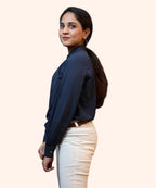 Side profile shot illustrating the regular fit, sleeve drape, and clean shoulder cut of a navy blue corporate top by Ladymade.