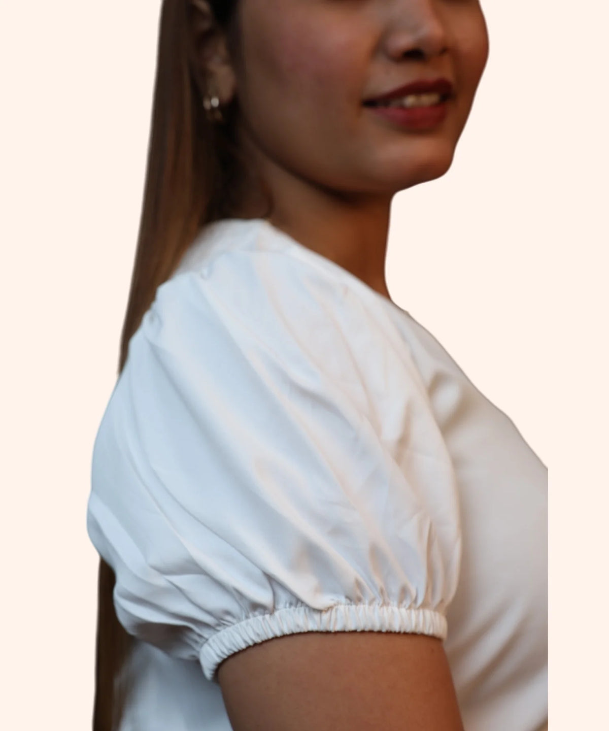 Extreme close-up view showing the soft gathers and fine stitching on the puff sleeves of an off-white corporate blouse by Ladymade.