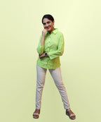 Full length view of women's parrot green schiffli embroidered shirt with white trousers Ladymade
