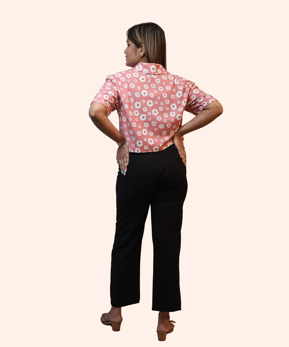Full back profile view showcasing the clean hemline of a women's peach pink daisy crop top by Ladymade.