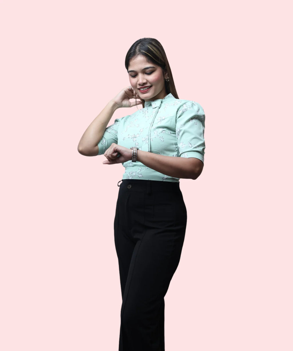 Women's pista green floral print mock neck workwear top dynamic pose checking watch Ladymade