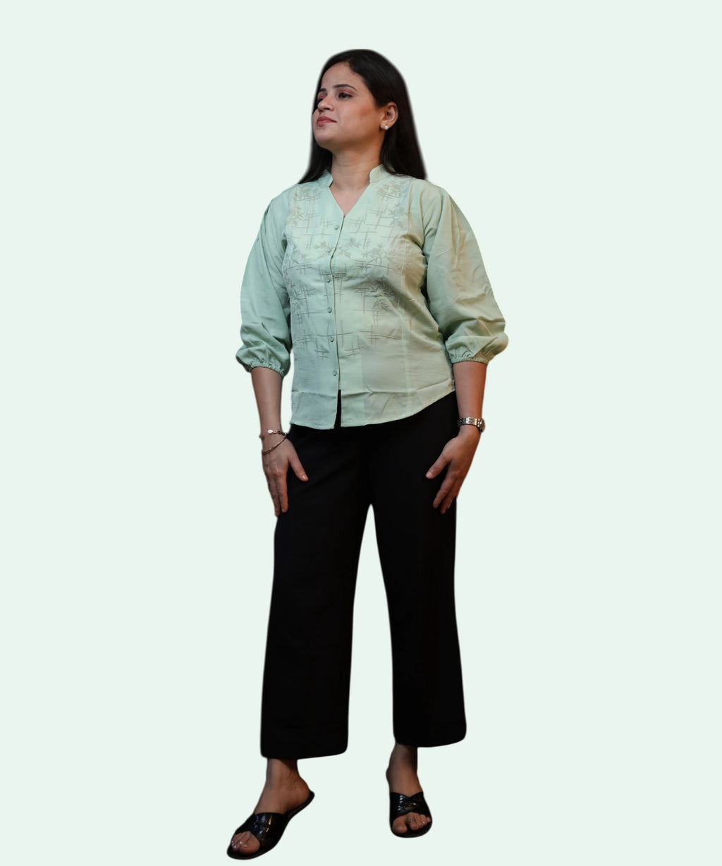 Full-length corporate look featuring an embroidered pista green cotton top paired with black wide-leg trousers by Ladymade.