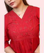 Close-up of floral embroidery on red workwear kurti Ladymade