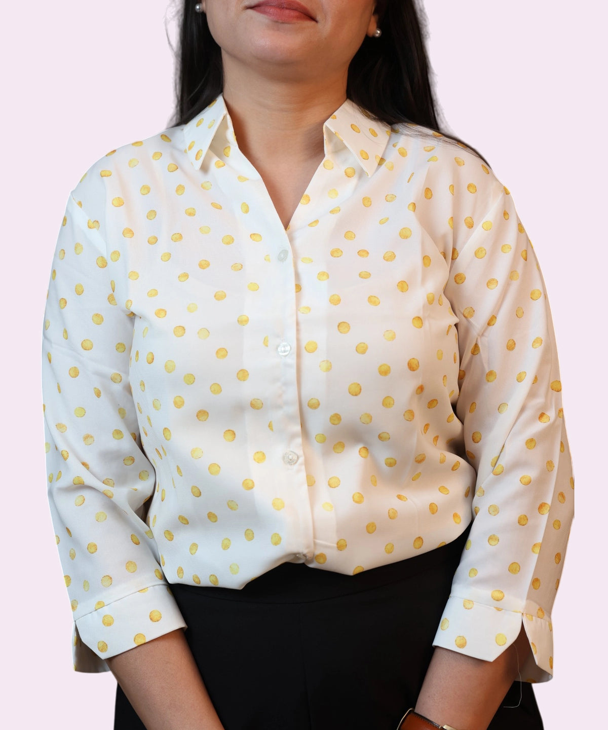 Close-up of the pointed collar and button-down front of a yellow polka dot formal shirt by Ladymade.