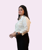 Side profile of a woman wearing a breathable cotton blend polka dot office shirt for women by Ladymade.