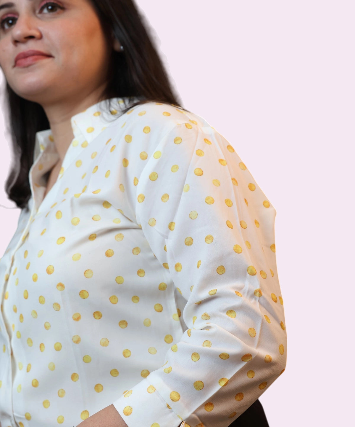 Close-up shot of the three-quarter sleeve and sun-kissed yellow print on a cotton blend shirt by Ladymade.